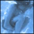 Pixelated blue-toned image with abstract dark shapes against a light blue background, appearing as an indistinct static icon.