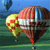 Static pixelated icon of a flying object with multiple colored sections against a blue sky and green ground background.