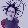 identical animated frames showing a person with spiky black hair, red lips, and pale skin against a light background with a circular symbol