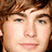 A pixelated portrait of a person with brown hair and blue eyes, featuring text overlays in two states.