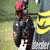 Animated contact sheet showing three sequential frames of a horse racing scene with jockeys in dark silks and red helmets, featuring yellow-and-black striped barriers on grassy terrain.
