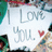 A static image with a green background, featuring text and an inset photo of a sign reading "I Love You" with a red heart.