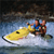 Pixelated static image of a person riding a yellow jet ski on water with dark background, rendered in low-resolution 256x256 pixels.