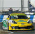 Yellow vehicle with dark windows and green accents appears in a pixelated scene with blue and gray background elements.