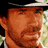 Pixelated image of a man with brown skin wearing a dark hat and light shirt, side-by-side views showing text overlay on right view.