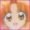 Anime-style character with large brown eyes and orange hair, featuring a small pink mouth and green-and-pink text in the top-left corner.