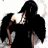 A pixelated figure with black wings and a dark hood stands against a white background, holding an object near its face.