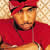 A pixelated portrait of a person wearing a red headband and red clothing against a light brown background.