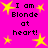 Bright pink background with yellow star shapes and black text reading "I am Blonde at heart!" in a pixelated font.