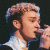 A pixelated contact sheet of two animated frames showing a person singing into a microphone on the left and green text reading "Original Icons .com" on the right against a dark background.