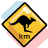 Yellow diamond-shaped road sign with black border, featuring a black kangaroo silhouette in mid-leap pose and partial brown text reading 'KRO' on lower portion.