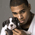 A pixelated image shows a person holding a small black and white dog against a gray background.