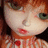 Pixelated close-up of a character with light skin, green eyes, and red lips wearing a red and white patterned garment.