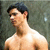 A shirtless man with dark hair stands against a textured green background, his head turned slightly left in the first frame and right in the second.
