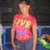 A person in a red and pink tie-dye shirt with yellow text stands against a dark background, shifting position across frames.