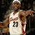 A basketball player in a white jersey with number 20 and red accents, holding a basketball near a hoop.