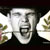 Pixelated static image of a person's face with mouth open in an exaggerated expression, surrounded by blurred floral elements on both sides against dark background.