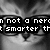 Black-and-white pixelated image of a cat's face with glasses, partially obscured text overlay reading "not a nerd smarter than" across multiple