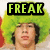 A pixelated image of a person with bright green afro hair wearing a black and yellow text overlay that changes from 'FREAK' to 'OUT'.