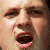 A pixelated close-up of a person's face showing eyes, nose, and mouth with mouth open in a shout or yell expression.