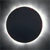 A circular dark gray icon with a bright white ring surrounding it, set against a gradient gray background.