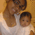 A woman in a white top holds a baby in a white outfit against a light brown background with pixelated texture.
