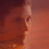 Pixelated static image of a character's face in profile view with warm reddish-brown tones and visible dithering patterns.