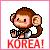 Pixelated monkey with brown fur, pink cheeks, and black eyes holds a gray object; red 'KOREA!' text below on white background.