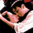 Pixelated static image of a couple in an intimate pose with visible pink and brown tones against black background, likely from Moulin Rouge film context.