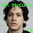 Pixelated portrait of a person with dark curly hair, green text reading 'Dr. McCutie' above the head, and a small green circular symbol in the bottom right corner.