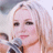 A 48x48 pixel animated buddy icon featuring a close-up of a person with blonde hair holding a microphone on the left, and green text reading "Original Icons .com" on a dark green dotted background on the right.