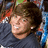 Pixelated image of a person with brown hair wearing dark clothing, next to blue text reading "MRS. RYAN SHECKLER" on black background.