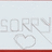 Pixelated text and heart symbol on light background with red border, transitioning to black background with blue text fragments.
