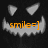 A pixelated pumpkin face with triangular eyes and jagged teeth, displaying orange text reading "smile=]" against a dark background.