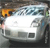 Pixelated static image of a white vehicle with dark windows and a light blue roof, positioned on a dark road with blurred background elements.