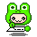 Green pixelated frog-costumed character with large black eyes and a small smile, holding a white keyboard-like object against a gray background.