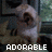 Pixelated image of a character with light-colored hair and dark eyes, wearing white clothing against a blurred background with the word "ADORABLE" in blocky text at bottom.