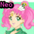 Pixelated anime-style character with pink hair and green eyes, wearing a green top with white floral hair accessories, displayed in a with text labels