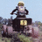 A person wearing a helmet and dark clothing rides an ATV with yellow license plate in outdoor setting, captured across showing motion blur
