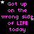 Pixelated text repeats 'Got up on the wrong side of LIFE today' with pink letters and scattered stars on a black background, featuring animated star movements.