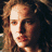 A 4-frame contact sheet of a pixelated character with curly brown hair in various poses and expressions, alongside a stylized gray symbol on black background.