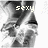 Black-and-white pixelated image of a person with flowing hair and the word 'sexy' in light-colored text above them, transitioning to include an exclamation mark.