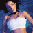 Pixelated static image of a person in a white bikini top against a blue background with dark areas.