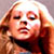 Static pixelated image of a person with light brown hair and closed eyes, wearing dark clothing against a neutral background.