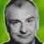 Pixelated grayscale portrait of a person with short hair against green background, static image.