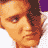 Pixelated static image of a person's face with orange-brown color palette and partial purple background element, rendered in low-resolution 48x48 pixels with visible dithering and pixelation artifacts.