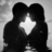 Black-and-white animation of two silhouetted figures embracing, with a bright star-shaped light between them; text appears sequentially below the pair.