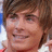 A pixelated image shows a person with brown hair and light skin on the left, next to blue text reading "I am in love with... Zac Efron" on a pink background.