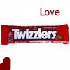 Red Twizzlers candy bar package with white text, a strawberry graphic, and a red heart shape below, with the word 'Love' in dark red text above.