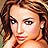 Pixelated close-up of a person with brown hair, light skin tone, and visible facial features including eyes, nose, mouth, and ear.